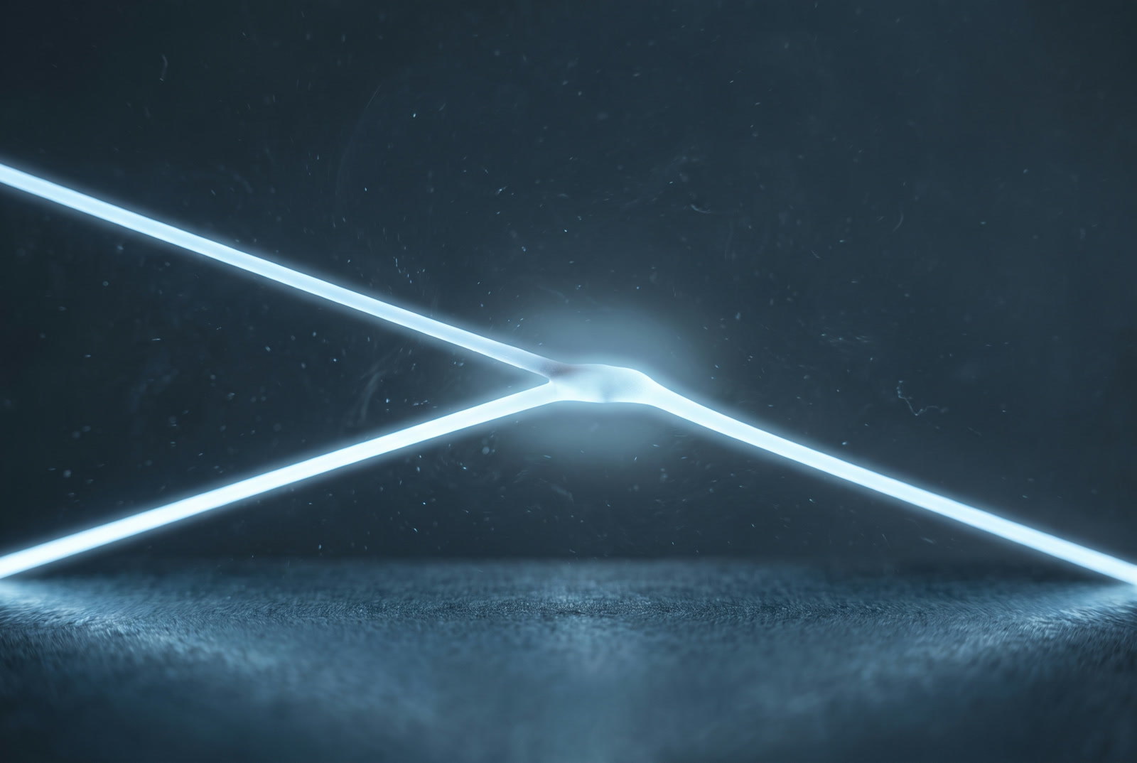 Two cold lines of light meeting and locking into a single precise joint.